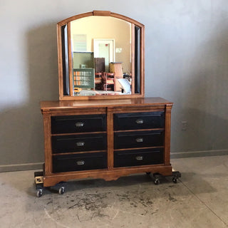 Brown and black dresser with mirror